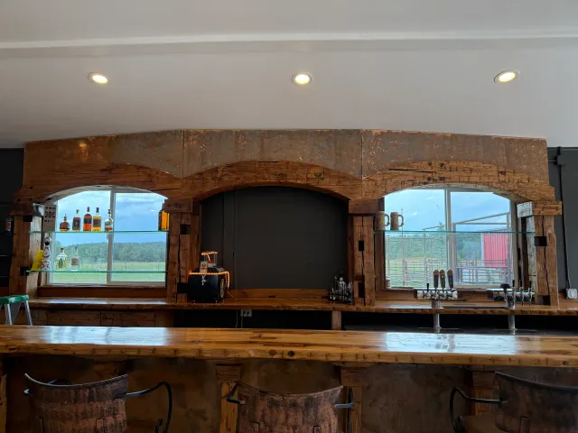 Finished bar with arched timber window surrounds and beer taps