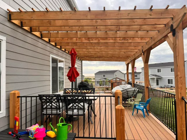 View under the cedar pergola across the deck's dining area