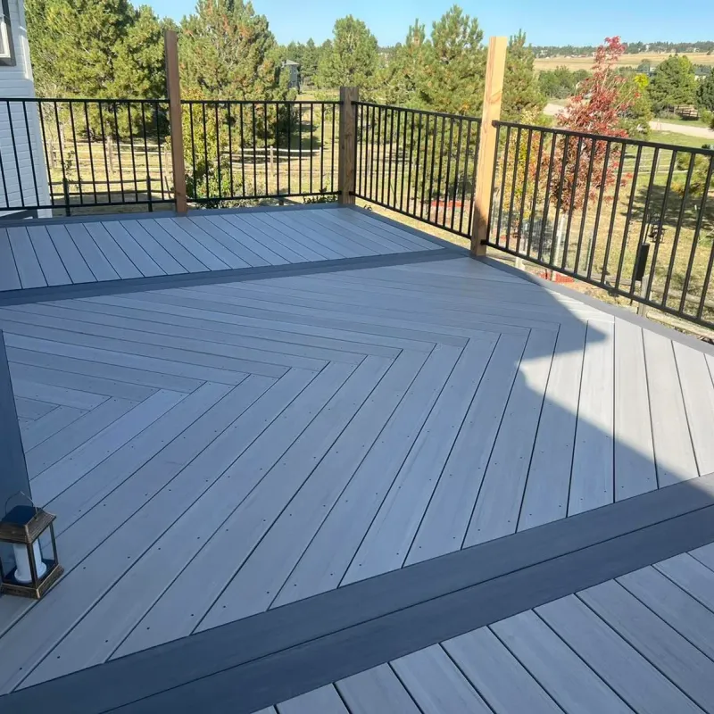 Gray composite deck with a herringbone inlay and dark picture-frame border
