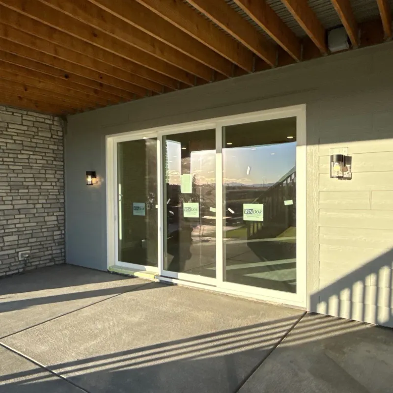 Covered concrete patio with a tongue-and-groove wood ceiling outside sliding doors