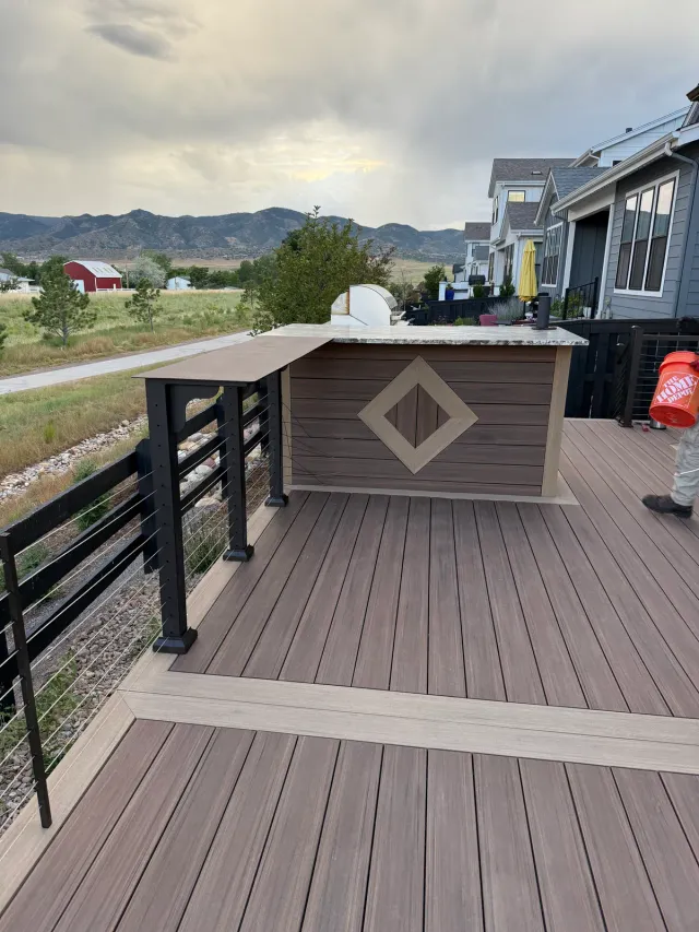 Composite deck with a built-in bar wall and diamond inlay, mountains in the distance
