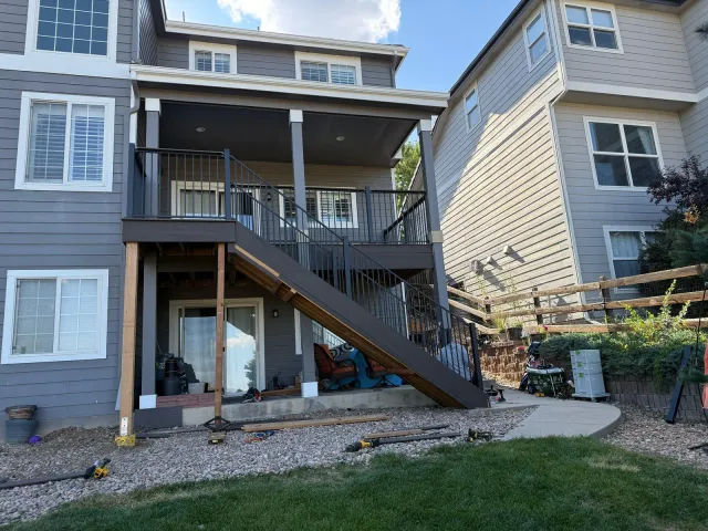 Second-story deck with a stair down to a covered patio below