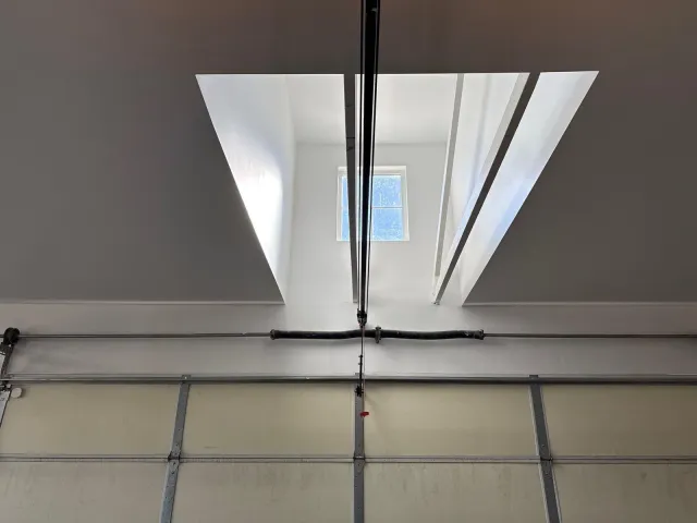 Drywalled skylight well above the garage door track