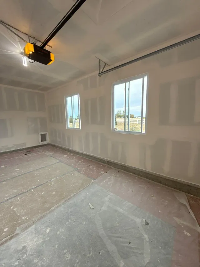 Garage walls with drywall taped and mudded, ready for paint