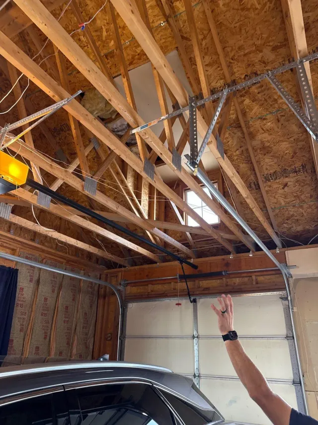 Exposed garage ceiling framing before insulation and drywall