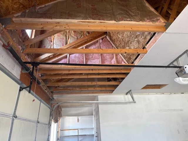 Insulated garage ceiling framing partway through drywall
