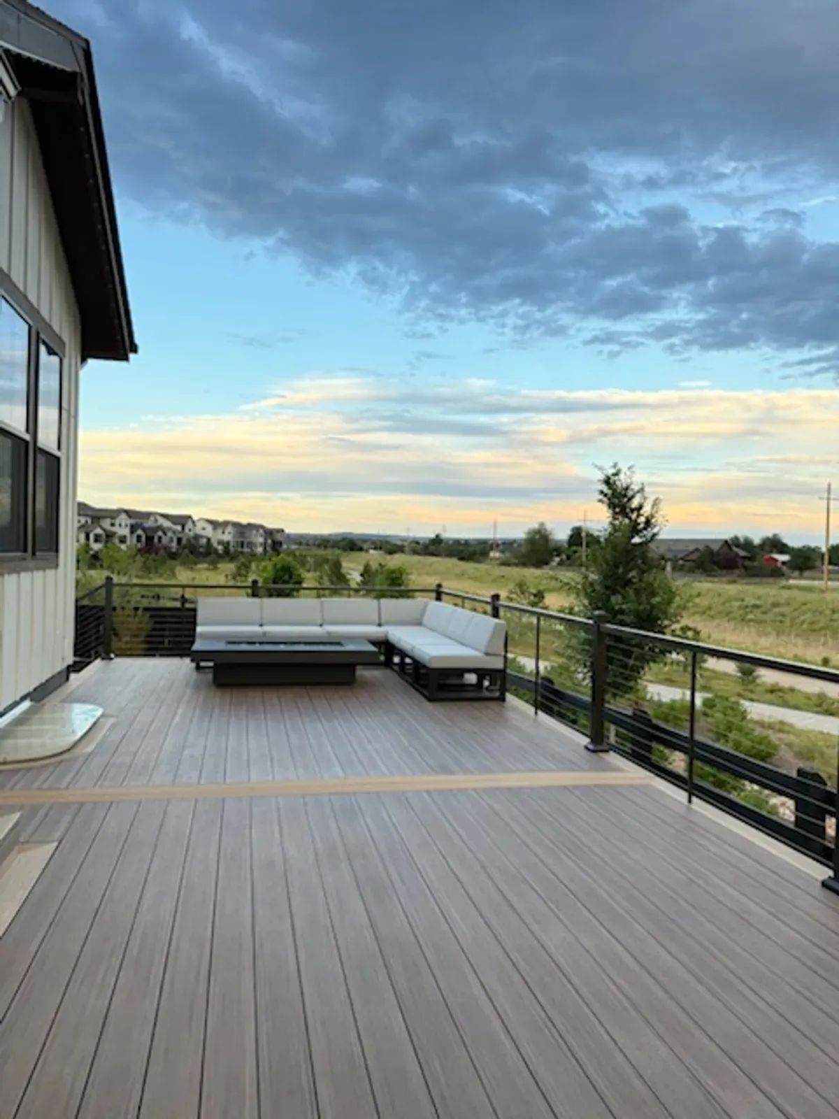 Brown composite patio deck with lounge seating and an open view