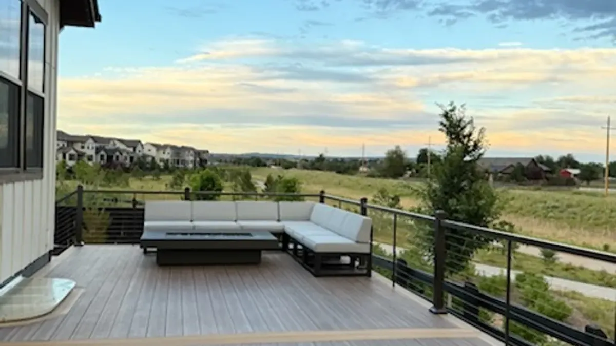 Brown composite patio deck with lounge seating and an open view