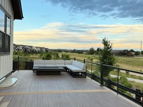 Brown composite patio deck with lounge seating and an open view